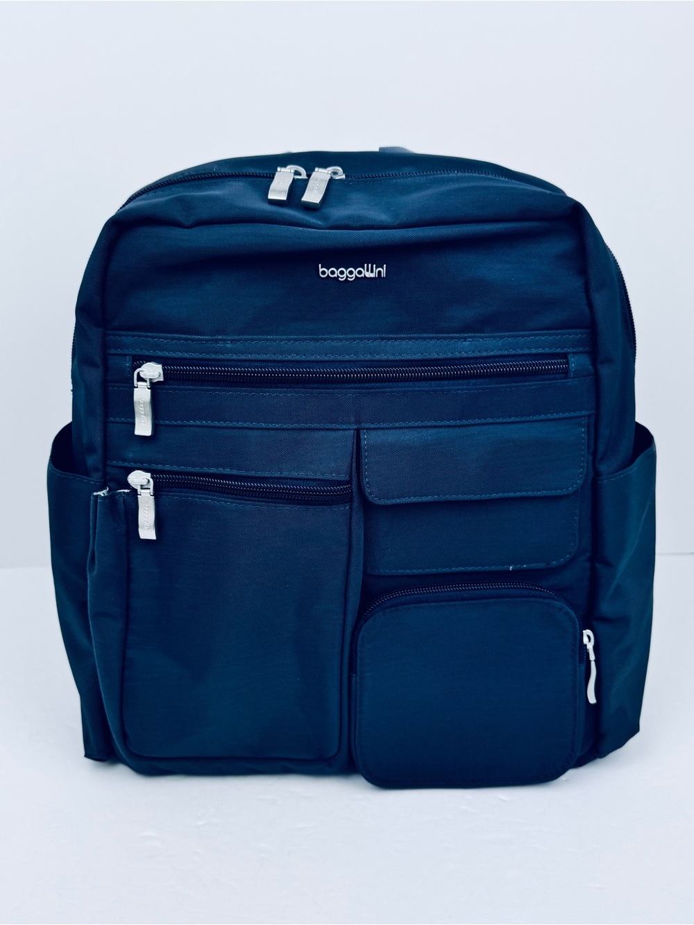 Baggallini Modern Excursion Backpack in Navy Blue. Multiple pockets. Very clean.